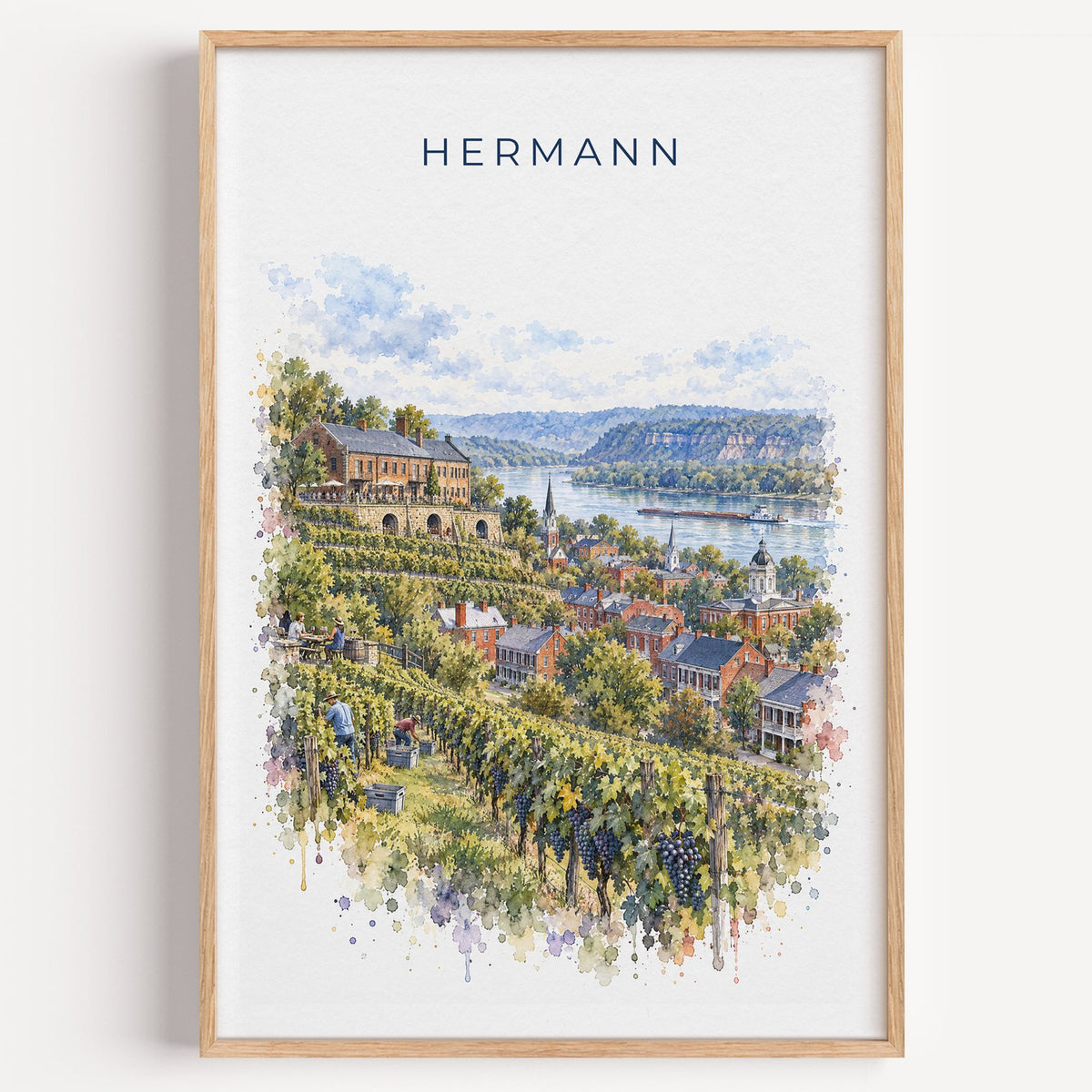 Hermann, Missouri watercolor print in a light oak frame on a plain white wall