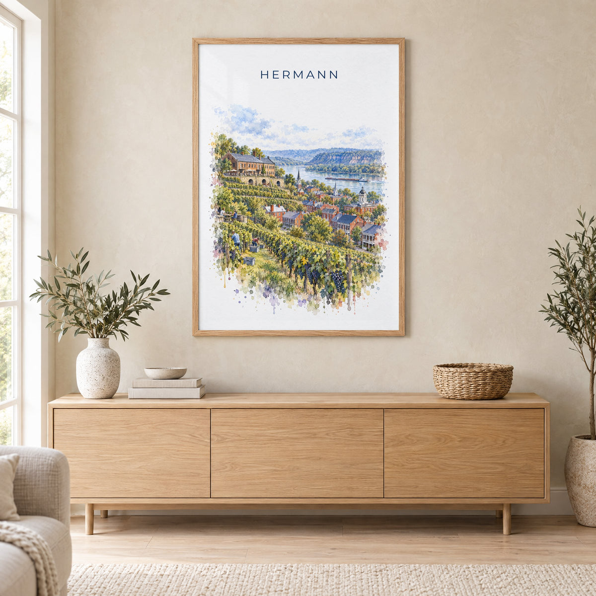 Hermann, Missouri watercolor print in an oak frame above a light wood sideboard in a Scandinavian living room