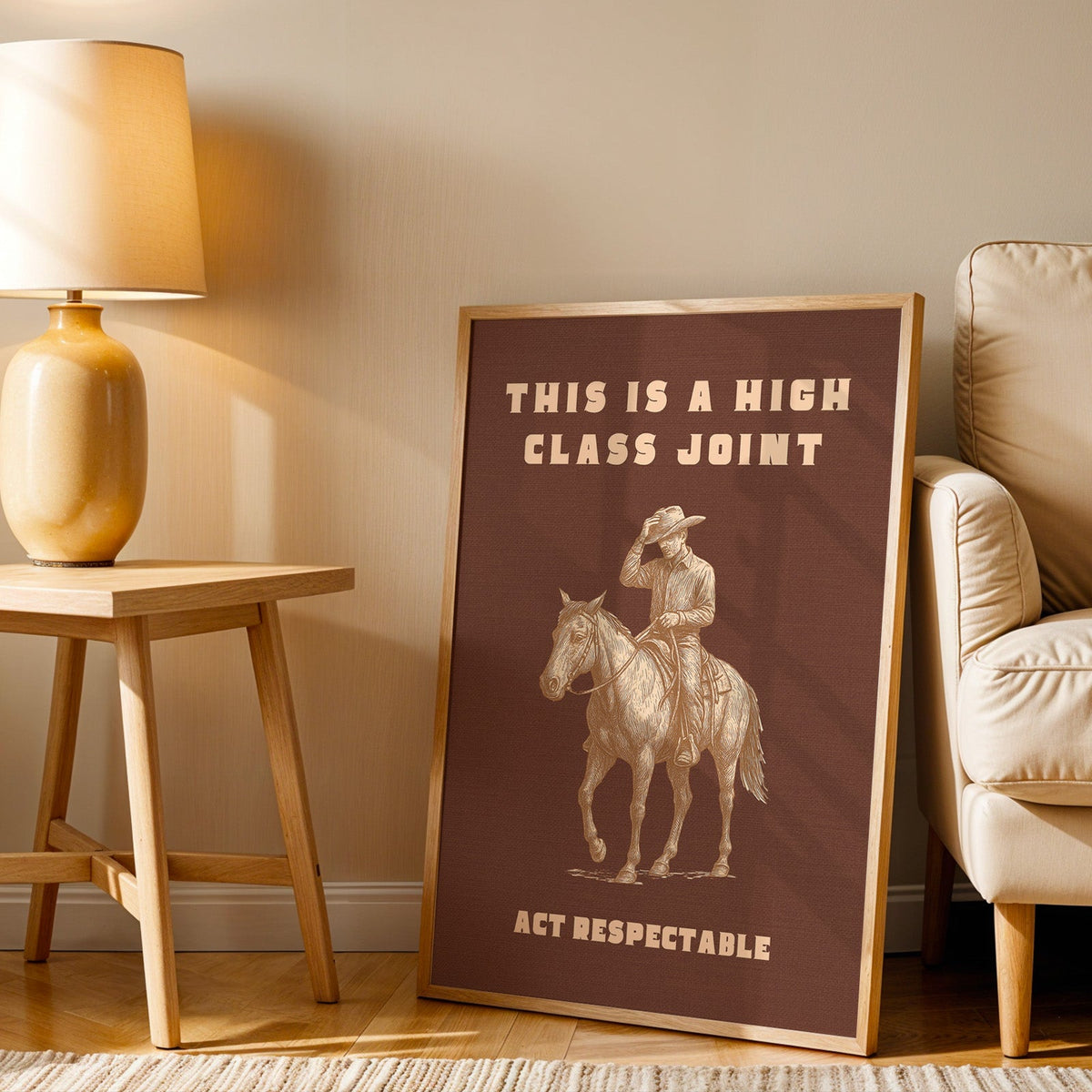 High Class Joint print in an oak frame beside an amber ceramic lamp