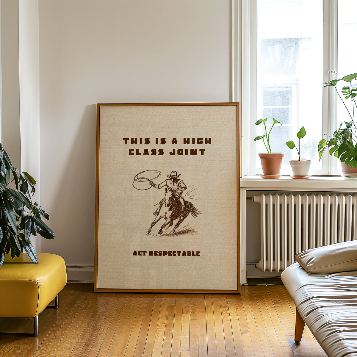 High Class Joint cowgirl cream print in an oak frame on a parquet floor beside a yellow bench