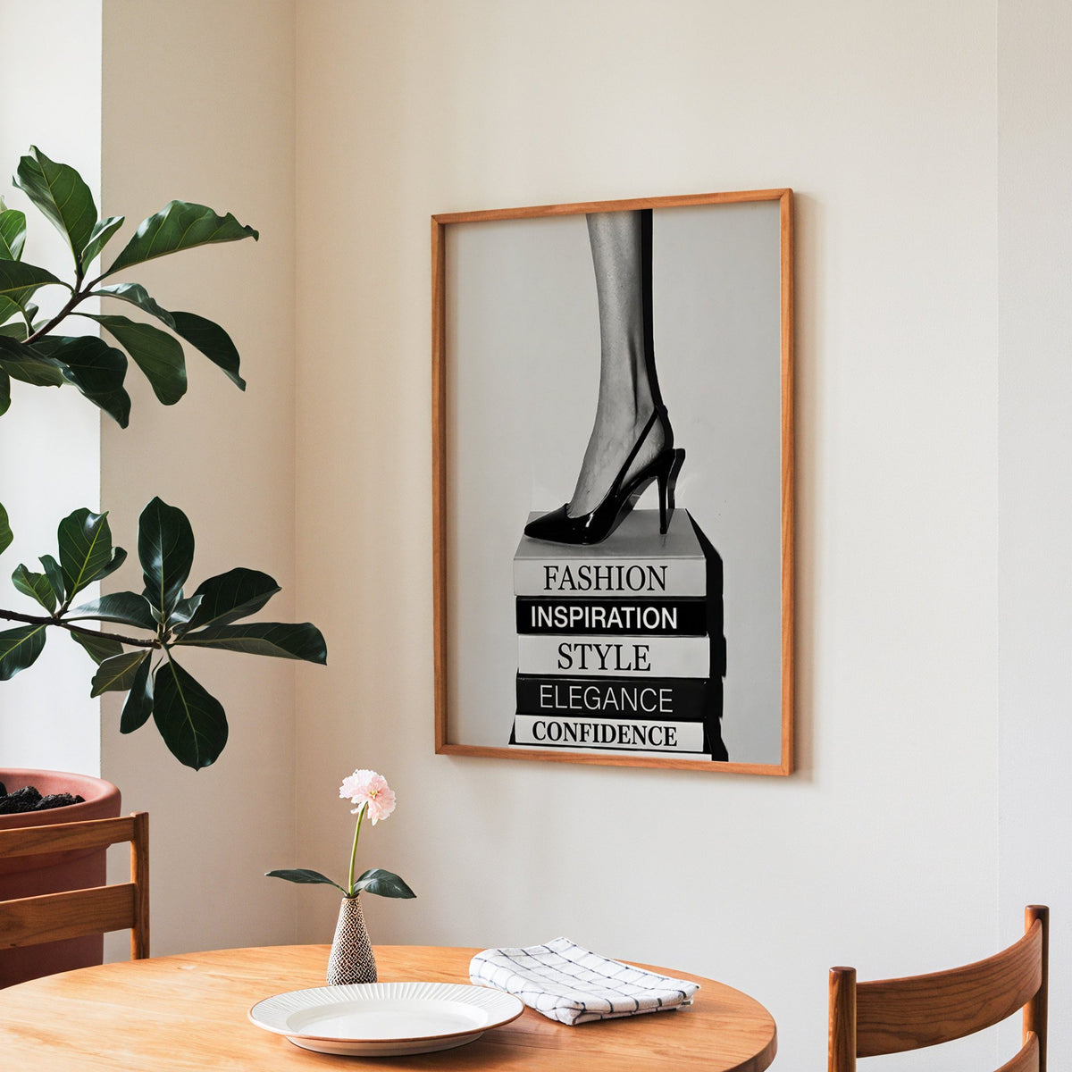Black slingback heel on stack of word books print in a teak frame above a round wooden dining table