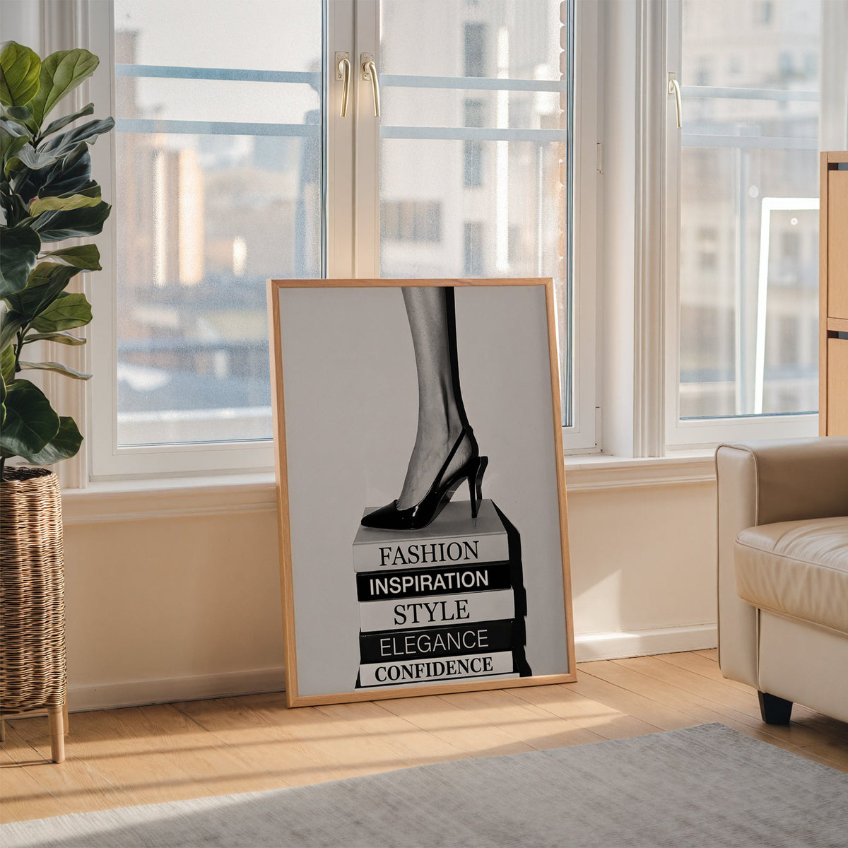 Black slingback heel on stack of word books print in an oak frame leaning on the floor beside a fiddle leaf fig
