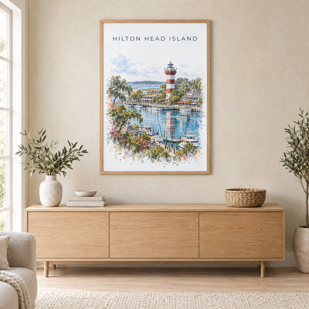 Hilton Head Island watercolor print in an oak frame above a light wood sideboard in a Scandinavian living room