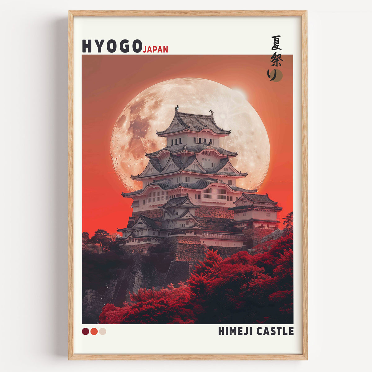 Himeji Castle red moon print in a light oak frame on a plain white wall