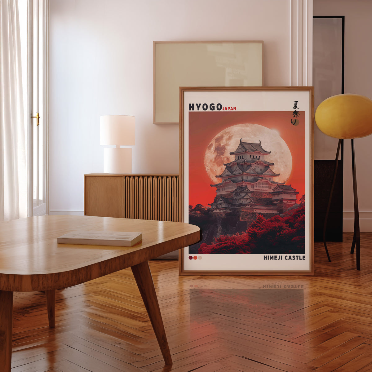 Himeji Castle red moon print in a walnut frame leaning in a mid-century living room