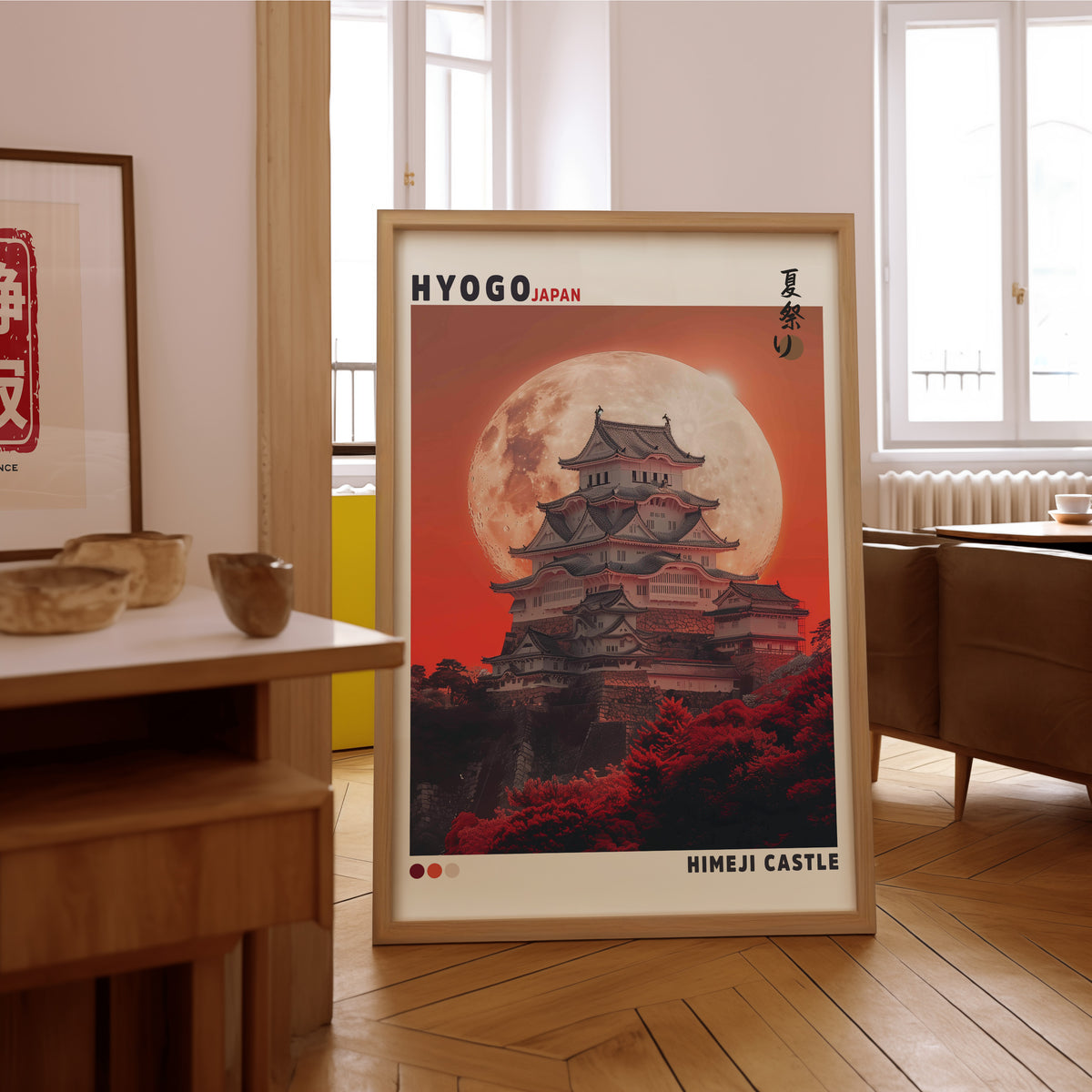 Himeji Castle red moon print in an oak frame on the parquet floor of a sunlit living room