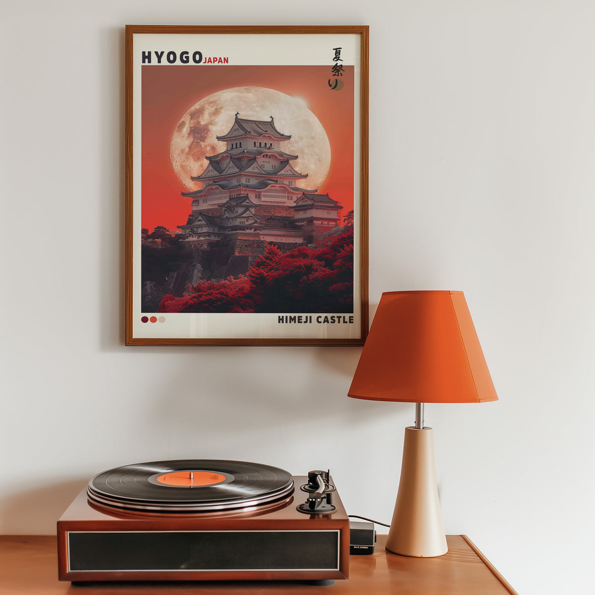 Himeji Castle red moon print in a walnut frame above a sideboard with a record player
