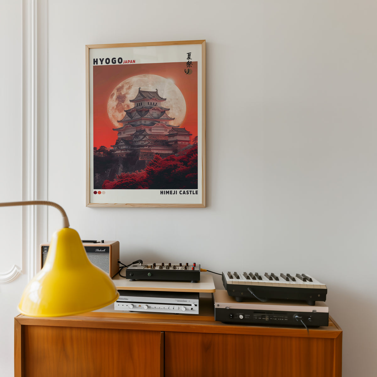 Himeji Castle red moon print in an oak frame above a teak sideboard with vintage hi-fi