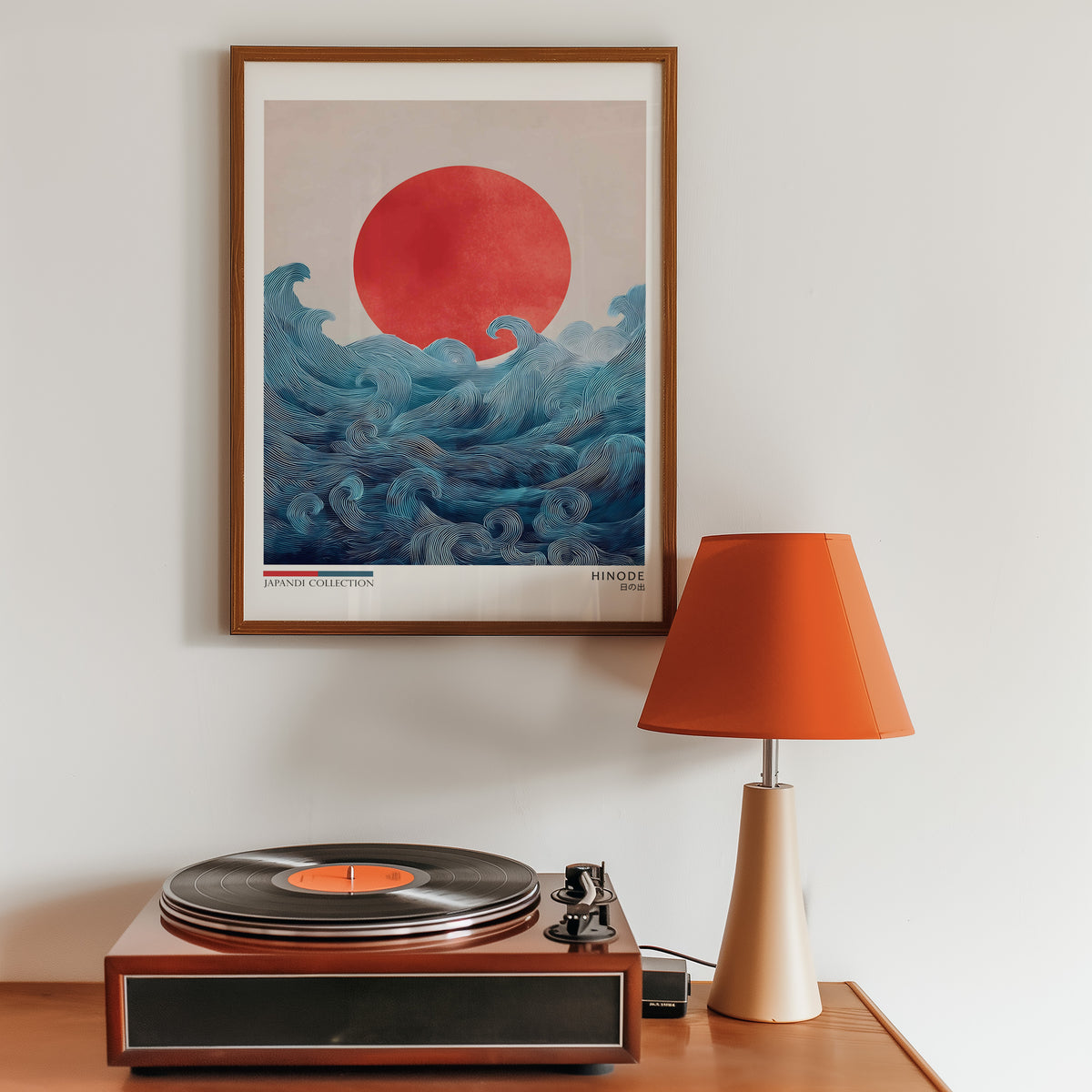 Hinode red sun over waves print in a walnut frame above a sideboard with a record player