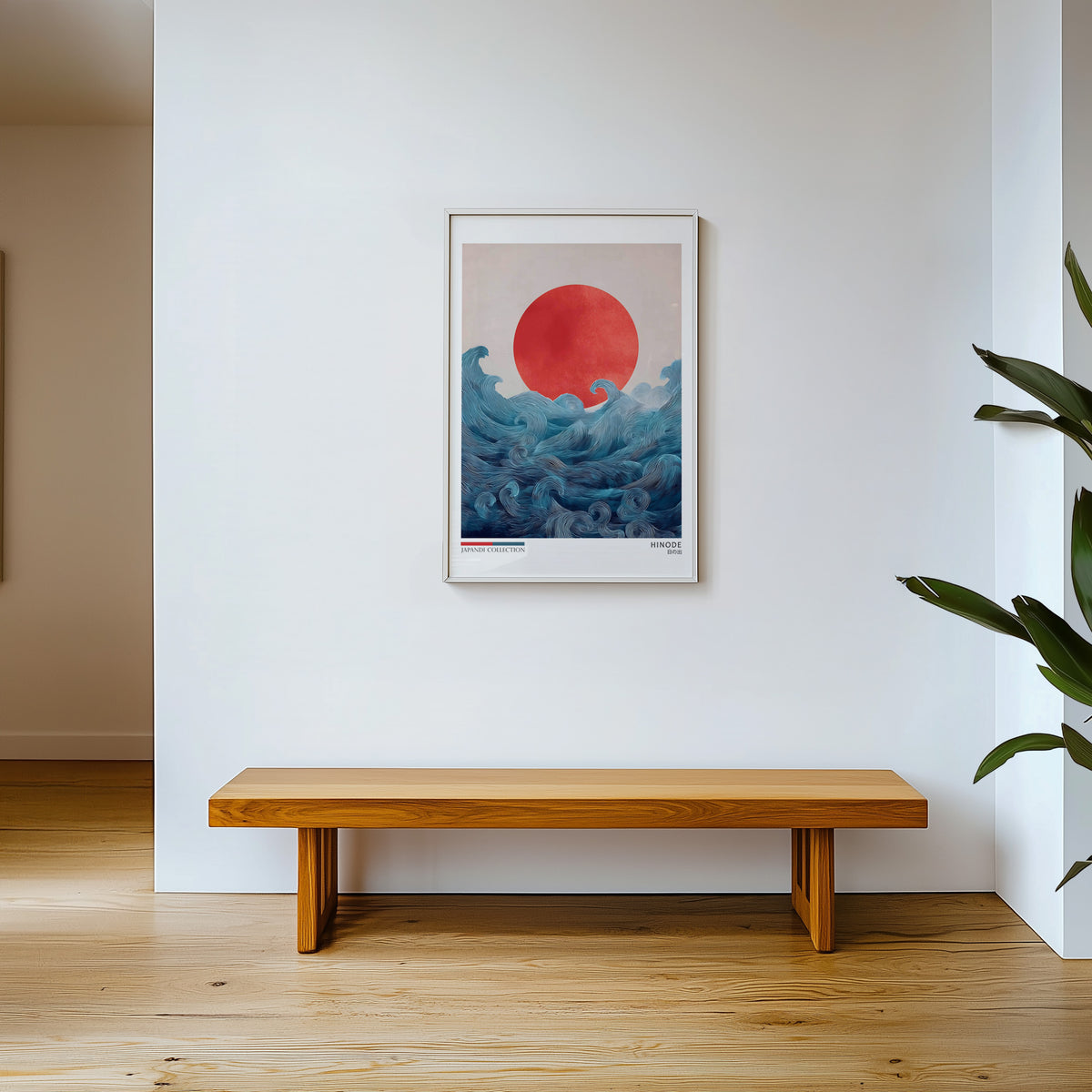 Hinode red sun over waves print shown in a white frame above a wooden entryway bench