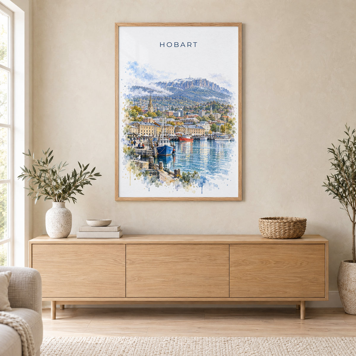 Hobart watercolor print in an oak frame above a light wood sideboard in a Scandinavian living room