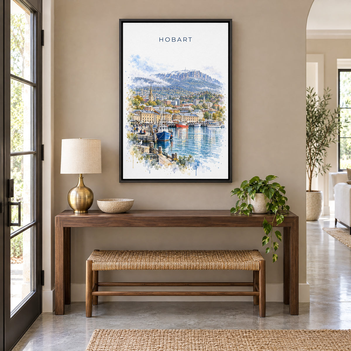 Hobart watercolor print as a black floater canvas above a walnut console and woven bench in an entryway