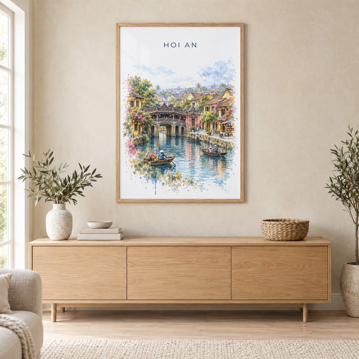 Hoi An watercolor print in an oak frame above a light wood sideboard in a Scandinavian living room