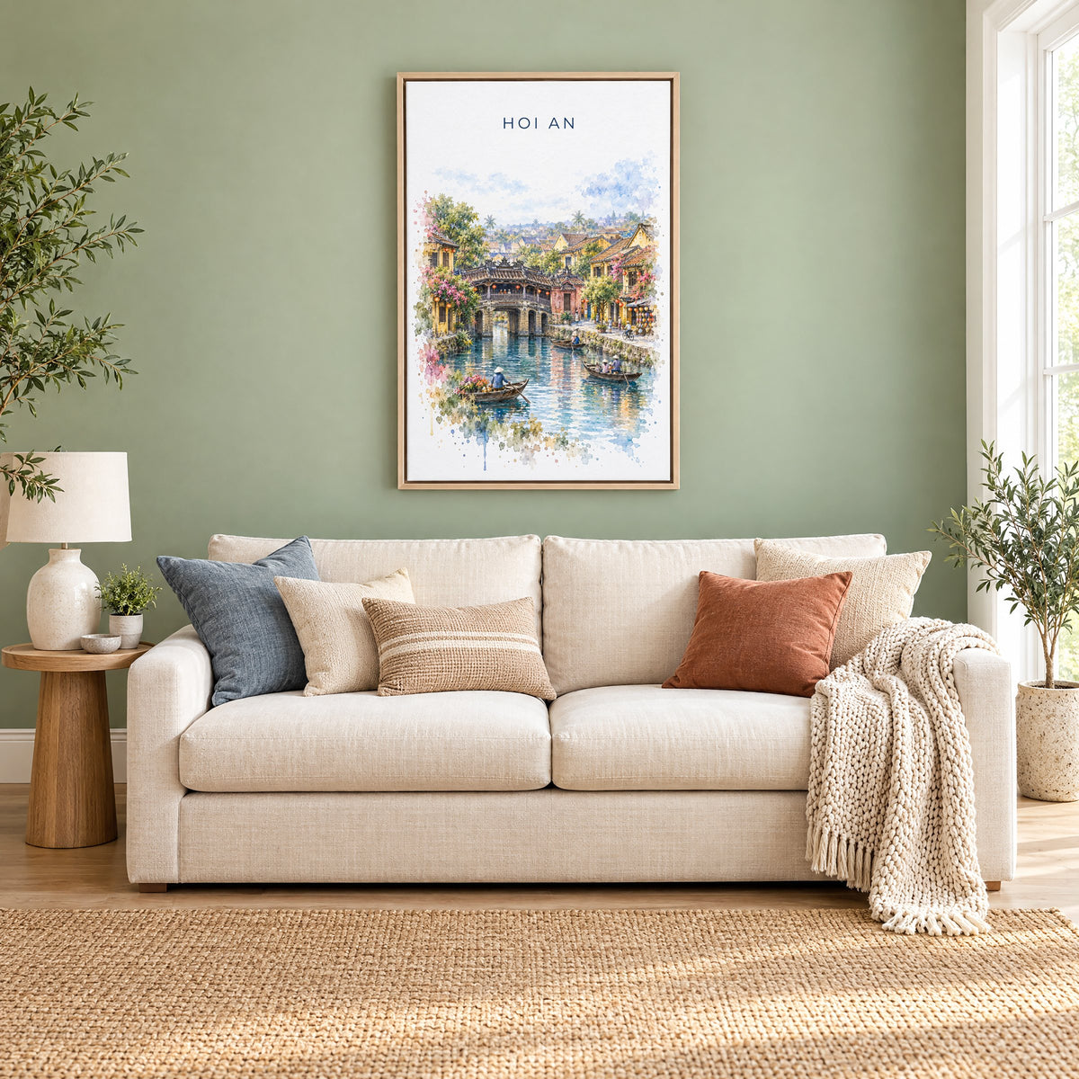 Hoi An watercolor print as a natural floater canvas above a cream linen sofa on a sage green wall