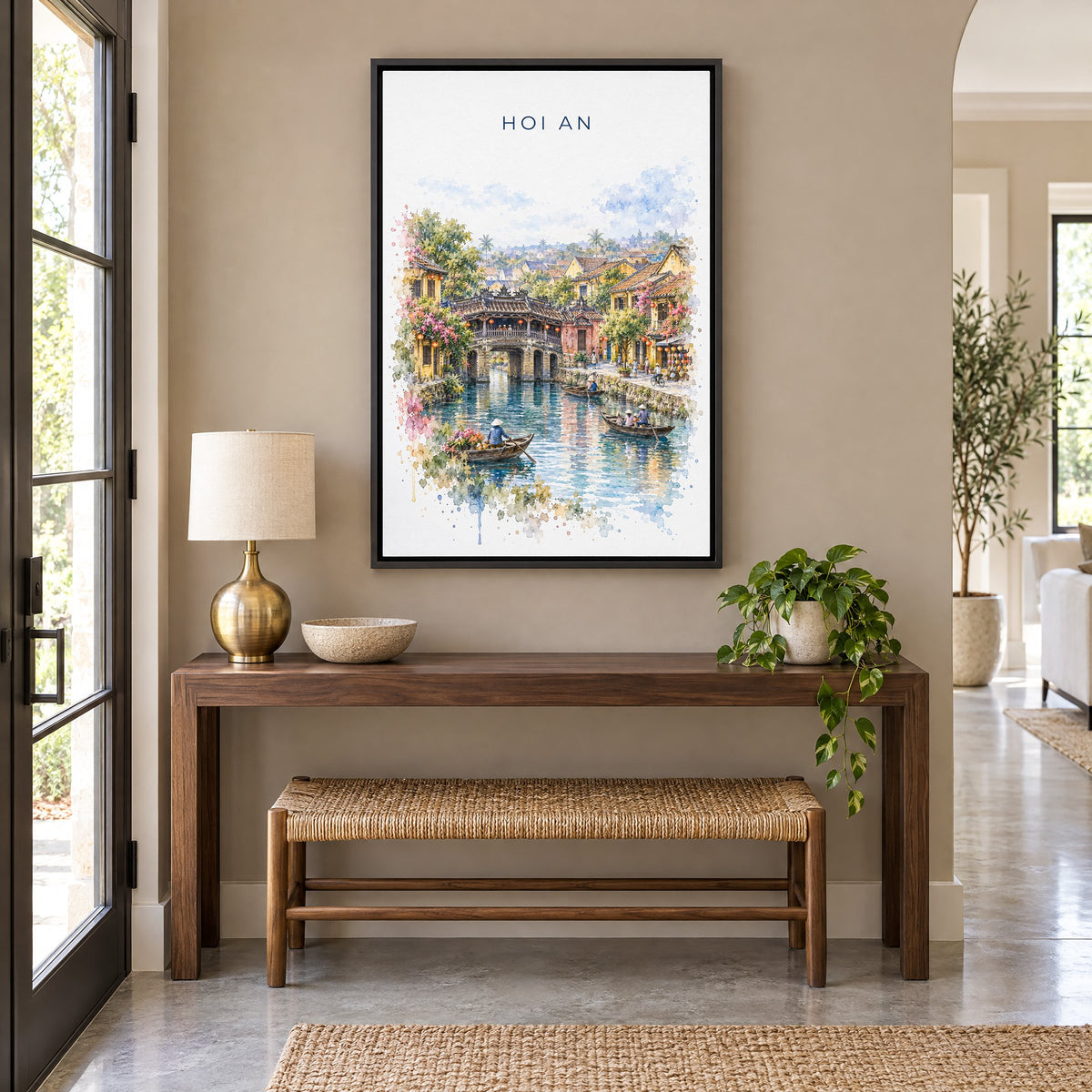 Hoi An watercolor print as a black floater canvas above a walnut console and woven bench in an entryway