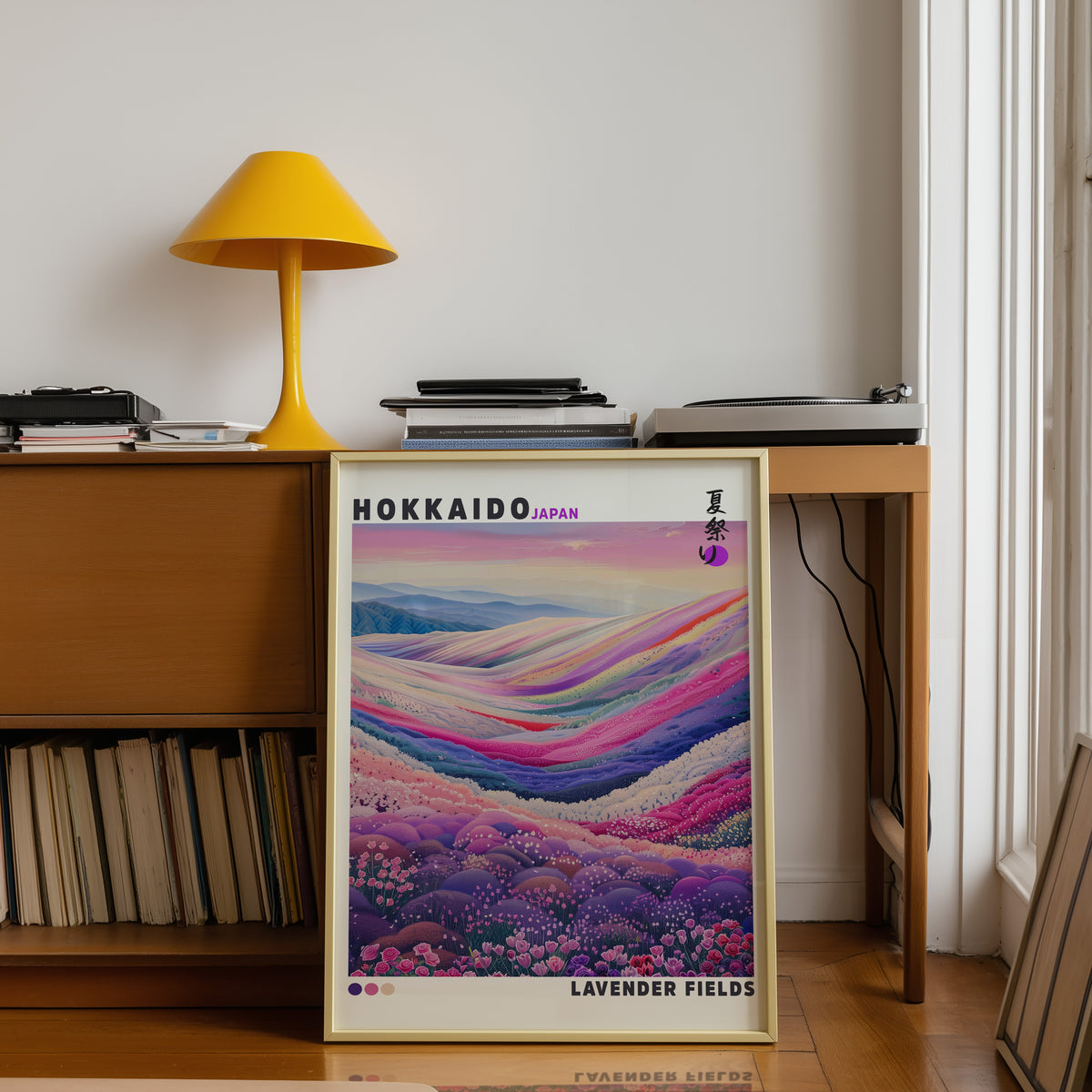 Hokkaido lavender fields print shown in a gold frame below a teak desk with a yellow lamp