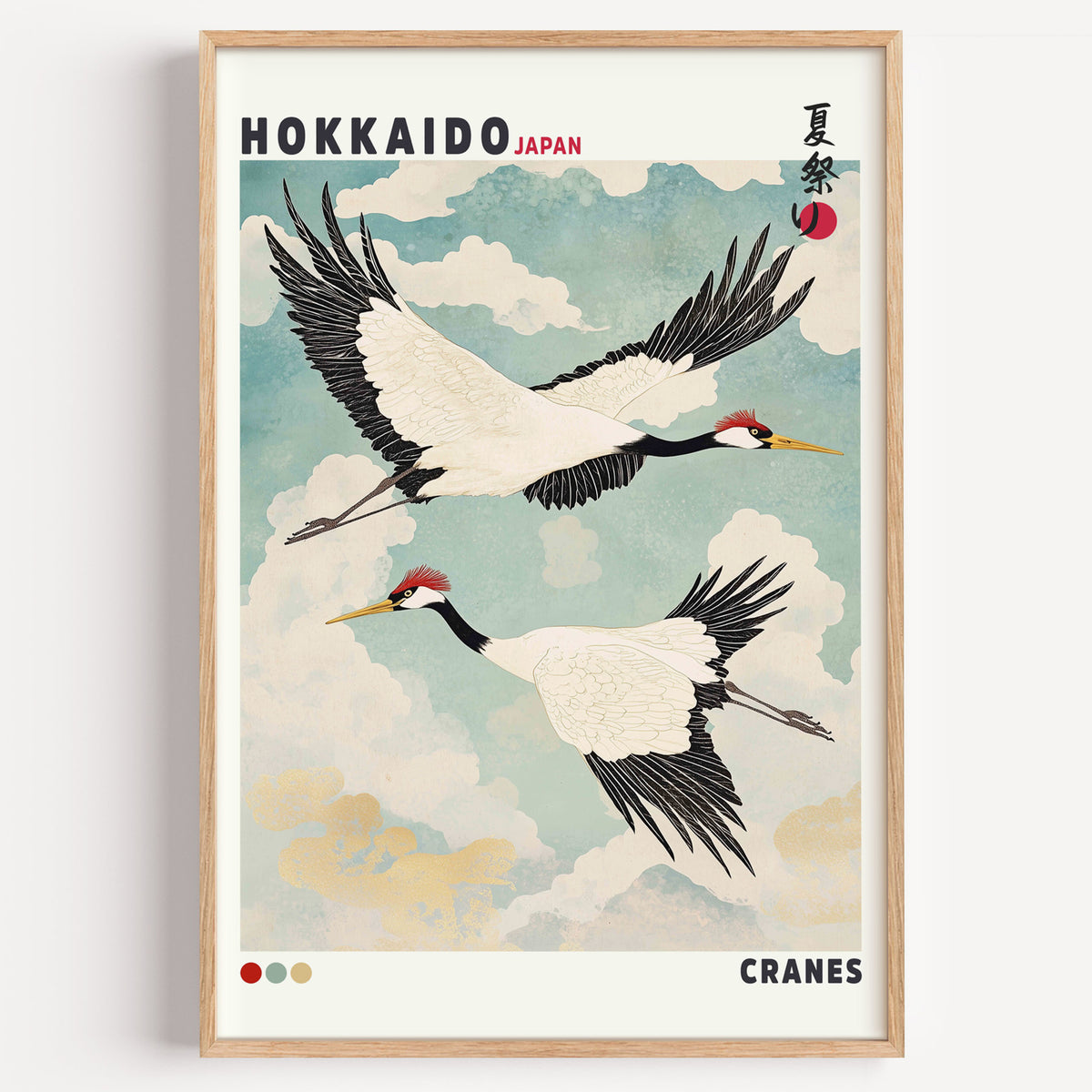 Hokkaido red-crowned cranes in flight print in a light oak frame on a plain white wall