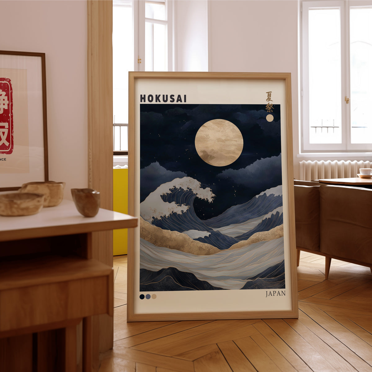 Hokusai night wave gold moon print in an oak frame on the parquet floor of a sunlit living room