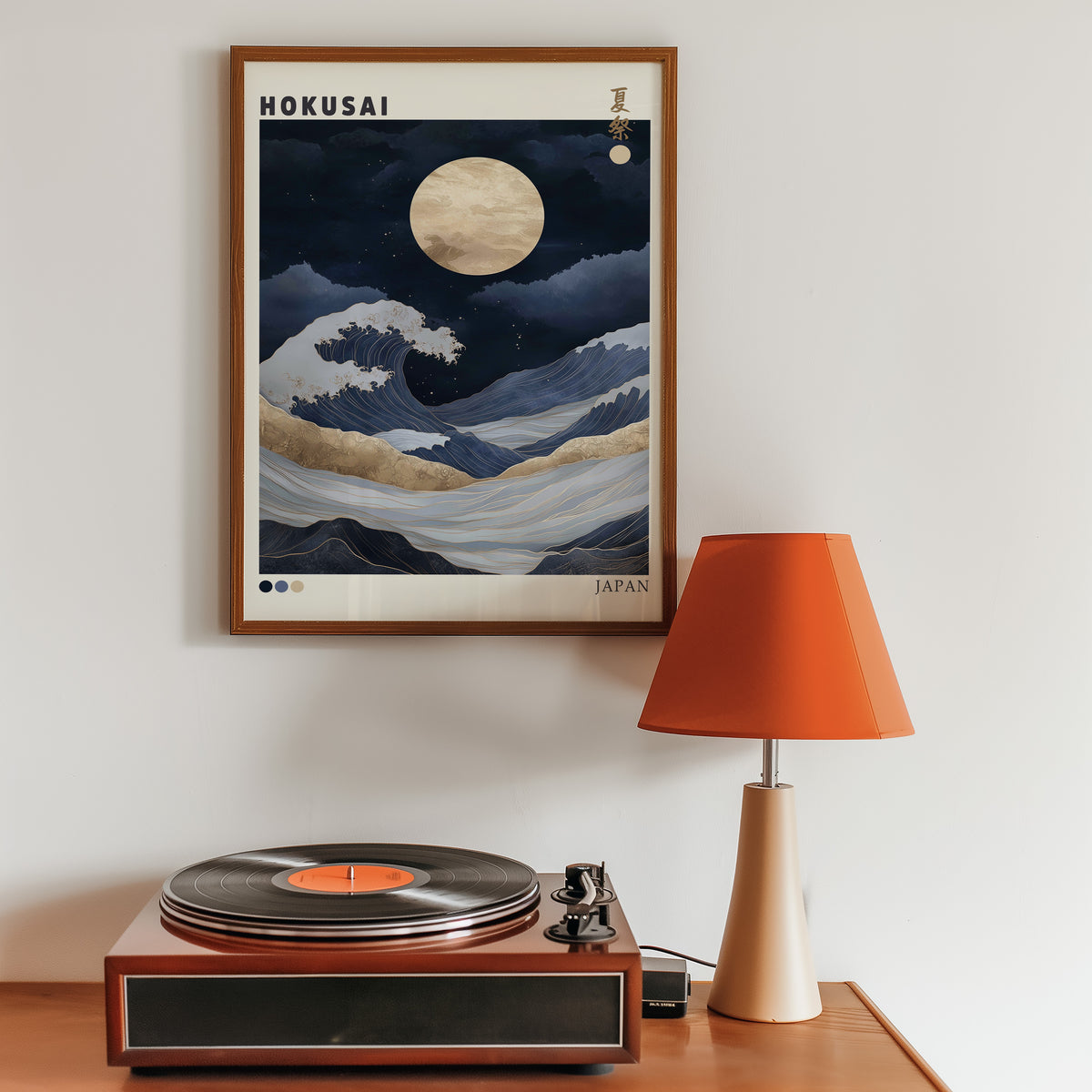 Hokusai night wave gold moon print in a walnut frame above a sideboard with a record player