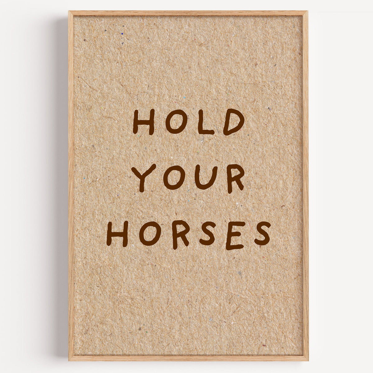 Hold Your Horses kraft print in a light oak frame on a plain white wall