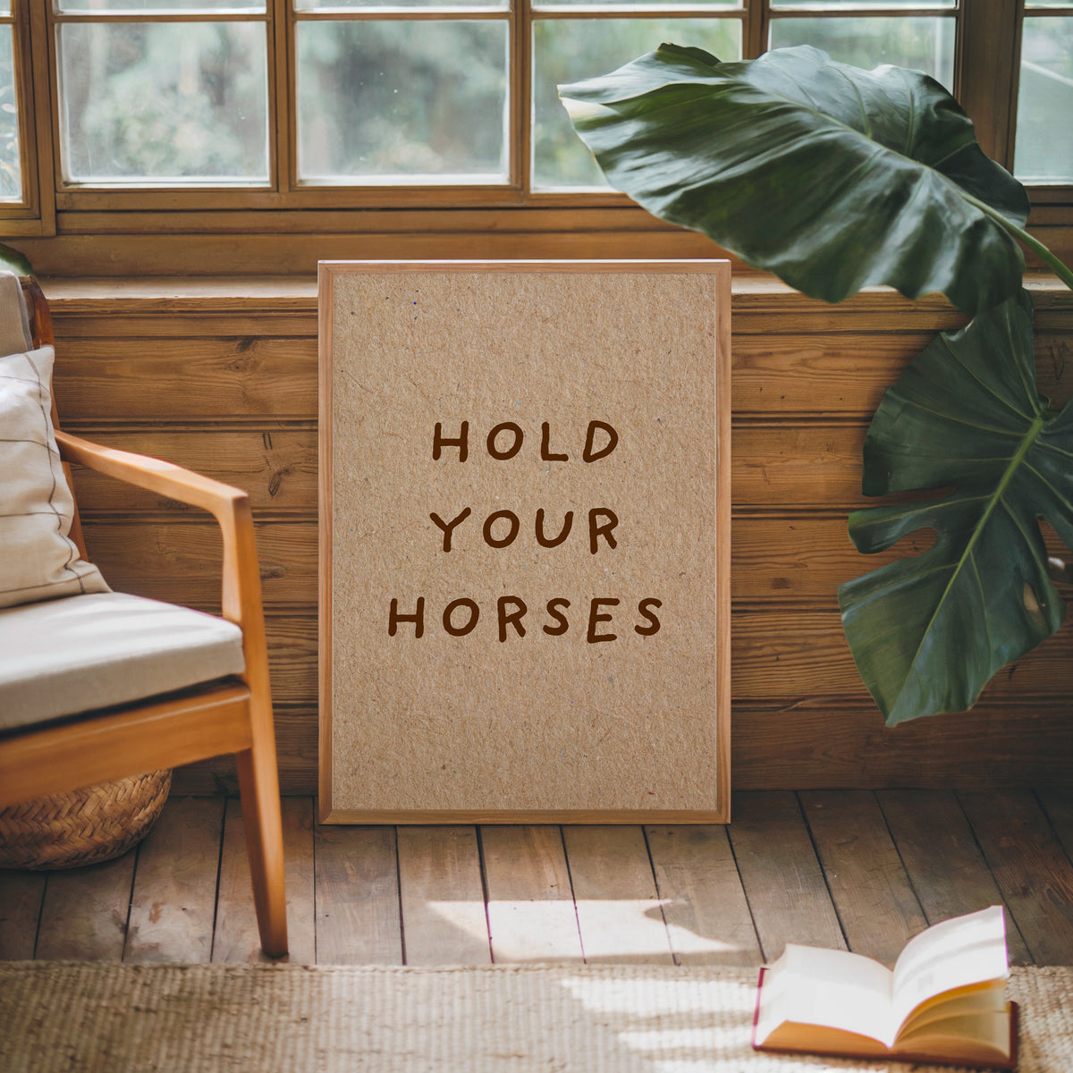 Hold Your Horses kraft print in an oak frame against a wood panel cabin wall