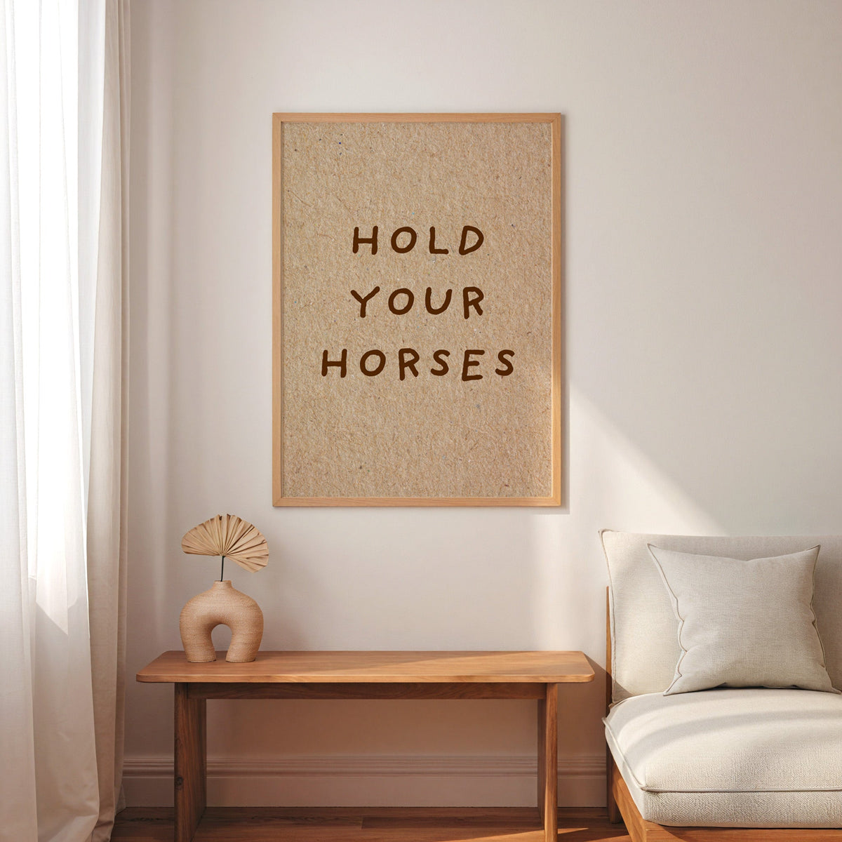 Hold Your Horses kraft print in an oak frame above a console with an arch vase