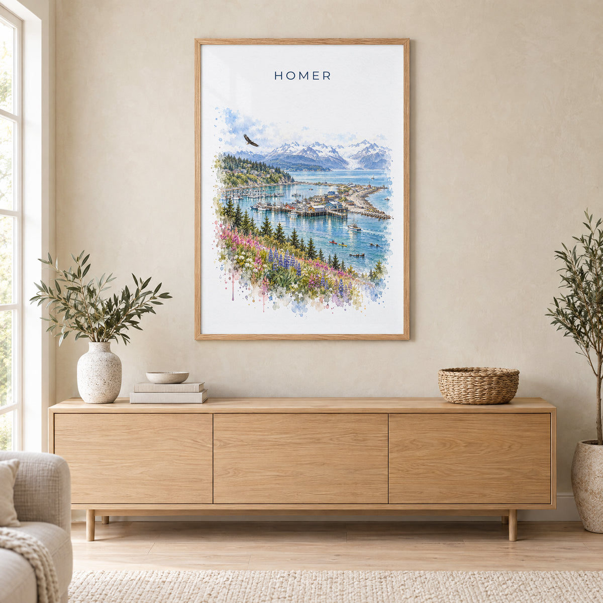 Homer, Alaska watercolor print in an oak frame above a light wood sideboard in a Scandinavian living room