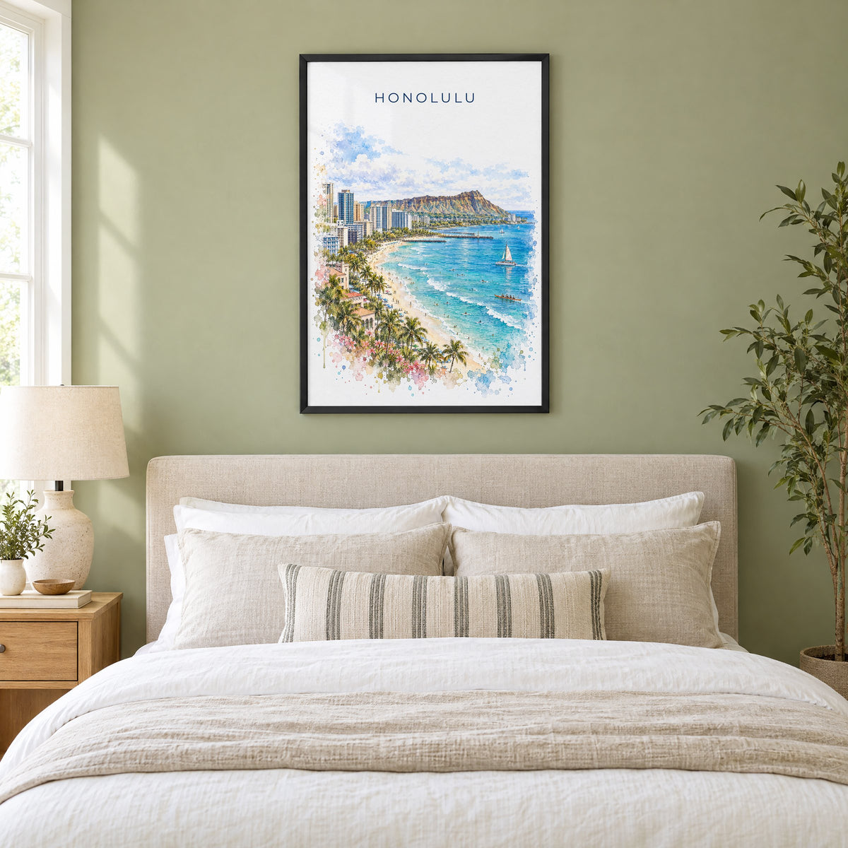 Honolulu watercolor print in a black frame above an upholstered headboard in a sage green bedroom