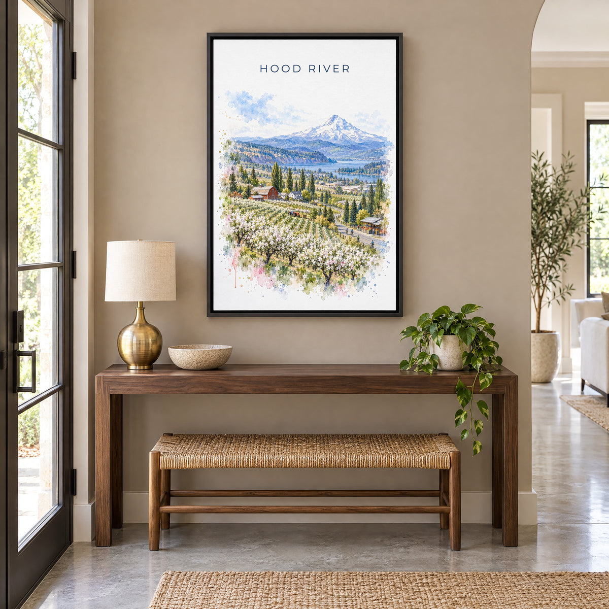Hood River watercolor print as a black floater canvas above a walnut console and woven bench in an entryway