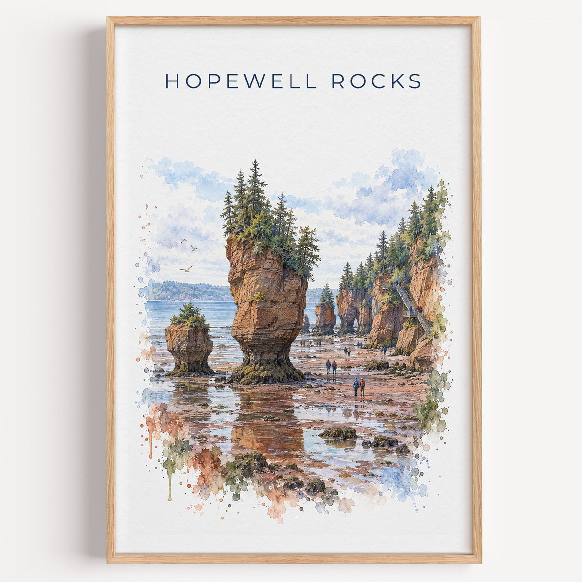 Hopewell Rocks watercolor print in a light oak frame on a plain white wall