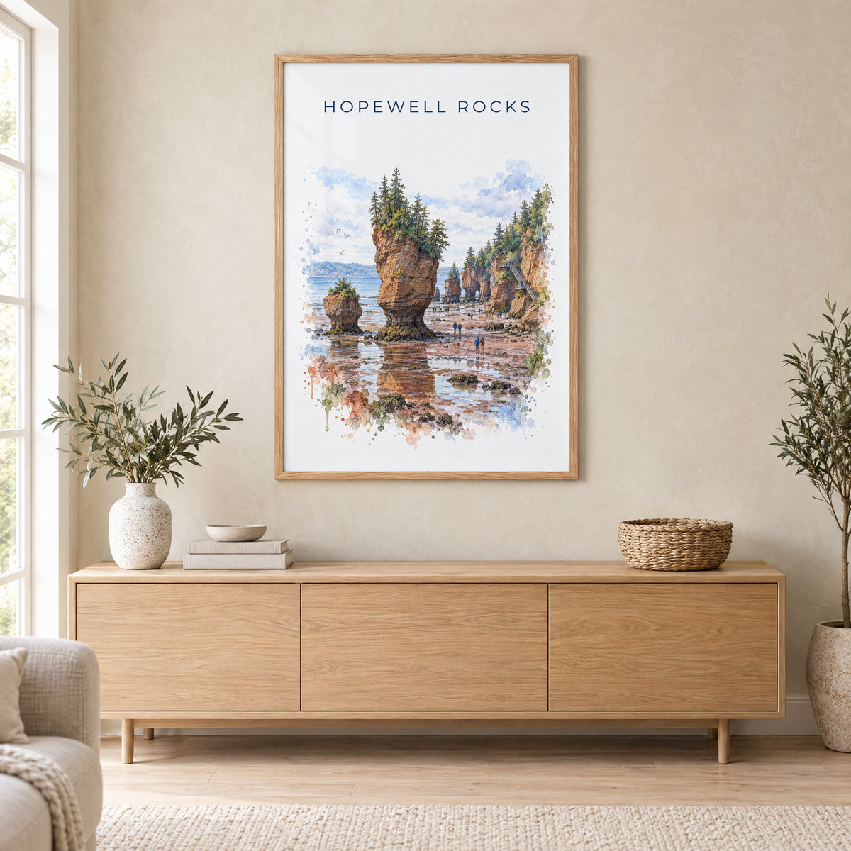 Hopewell Rocks watercolor print in an oak frame above a light wood sideboard in a Scandinavian living room