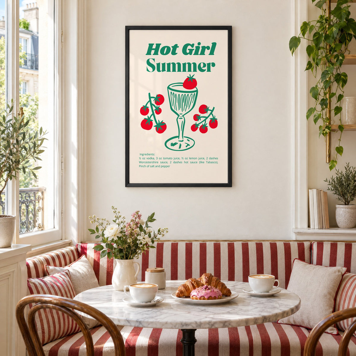 Hot Girl Summer tomato cocktail recipe print in a black frame above a striped cafe breakfast nook with cappuccino and pastries