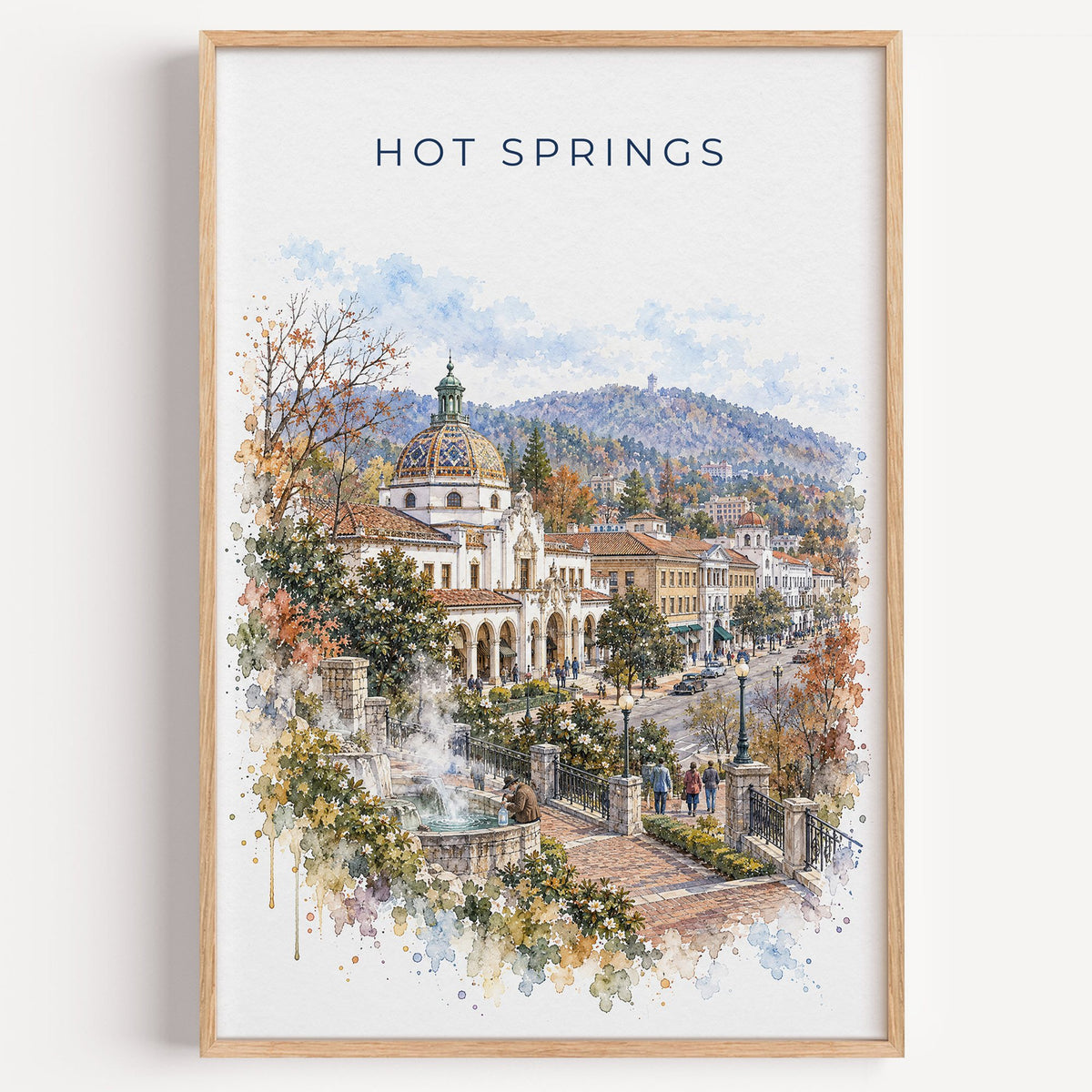 Hot Springs, Arkansas watercolor print in a light oak frame on a plain white wall