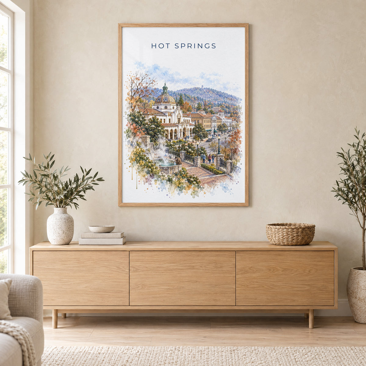 Hot Springs, Arkansas watercolor print in an oak frame above a light wood sideboard in a Scandinavian living room