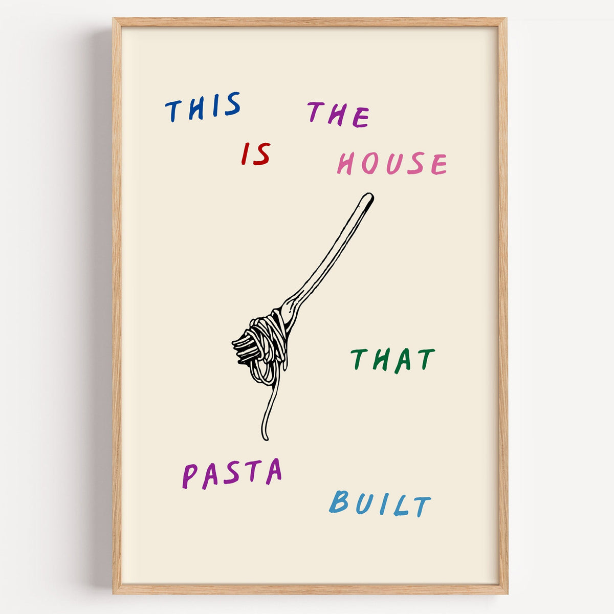 House That Pasta Built print in a light oak frame on a plain white wall