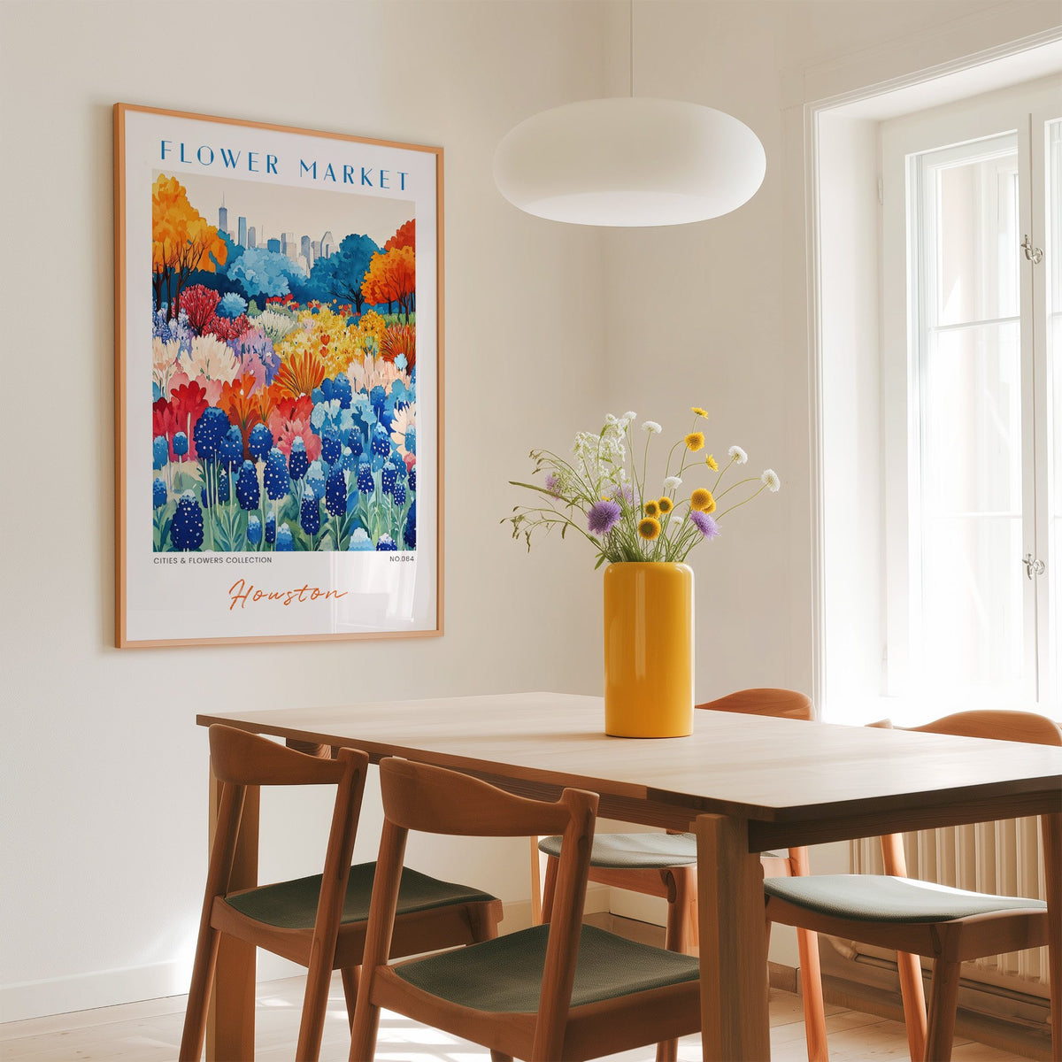 Houston flower market print in an oak frame above a dining table with a yellow vase and white pendant light