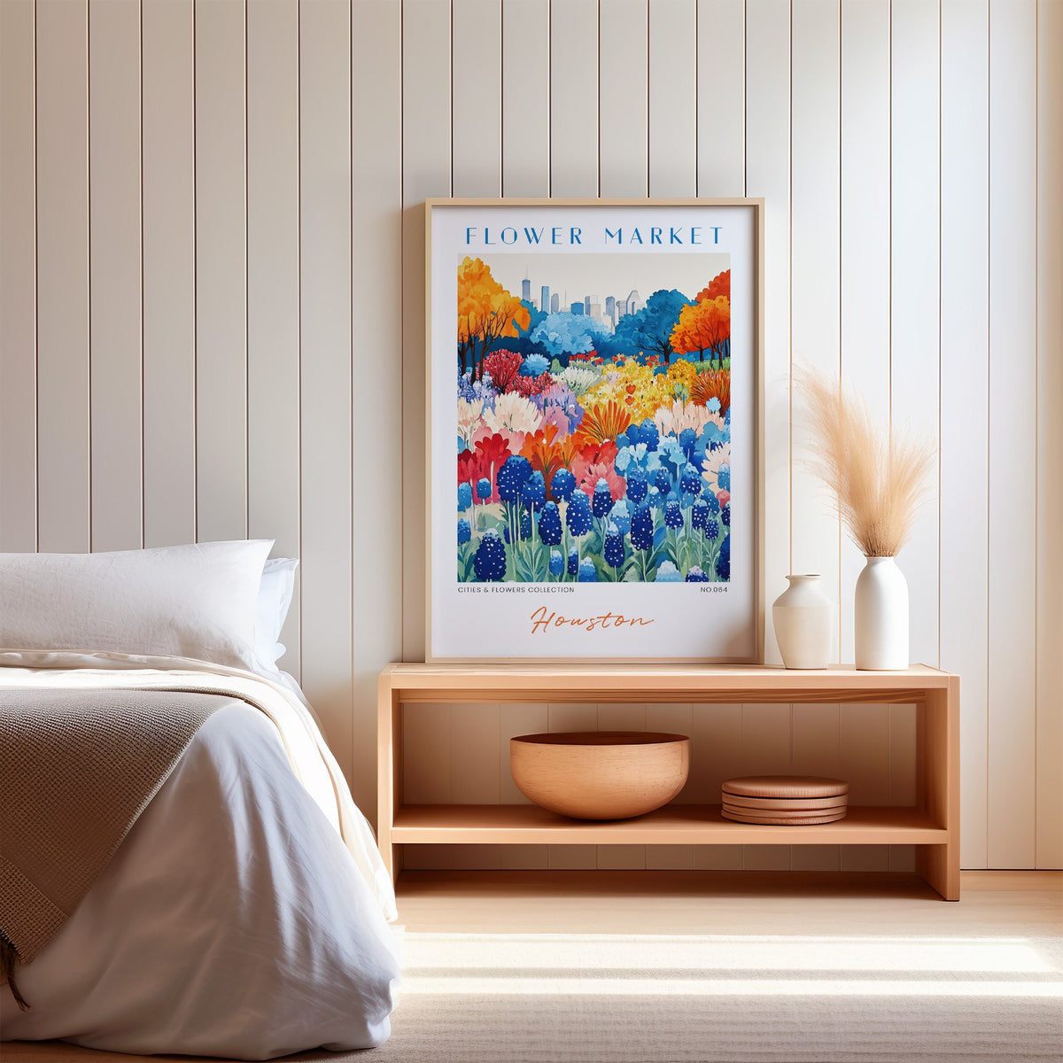 Houston flower market print in an oak frame on a wood bench against a white shiplap bedroom wall with pampas grass