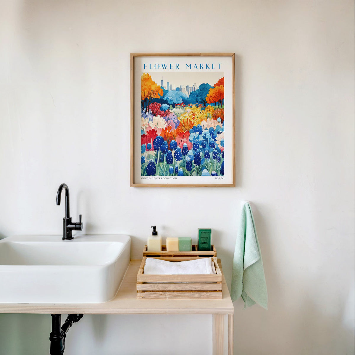 Houston flower market print in an oak frame above a white bathroom sink with folded towels