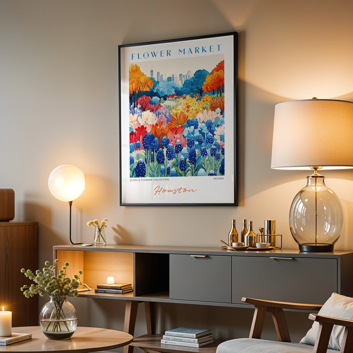 Houston flower market print in a black frame above a grey media console with a glass table lamp