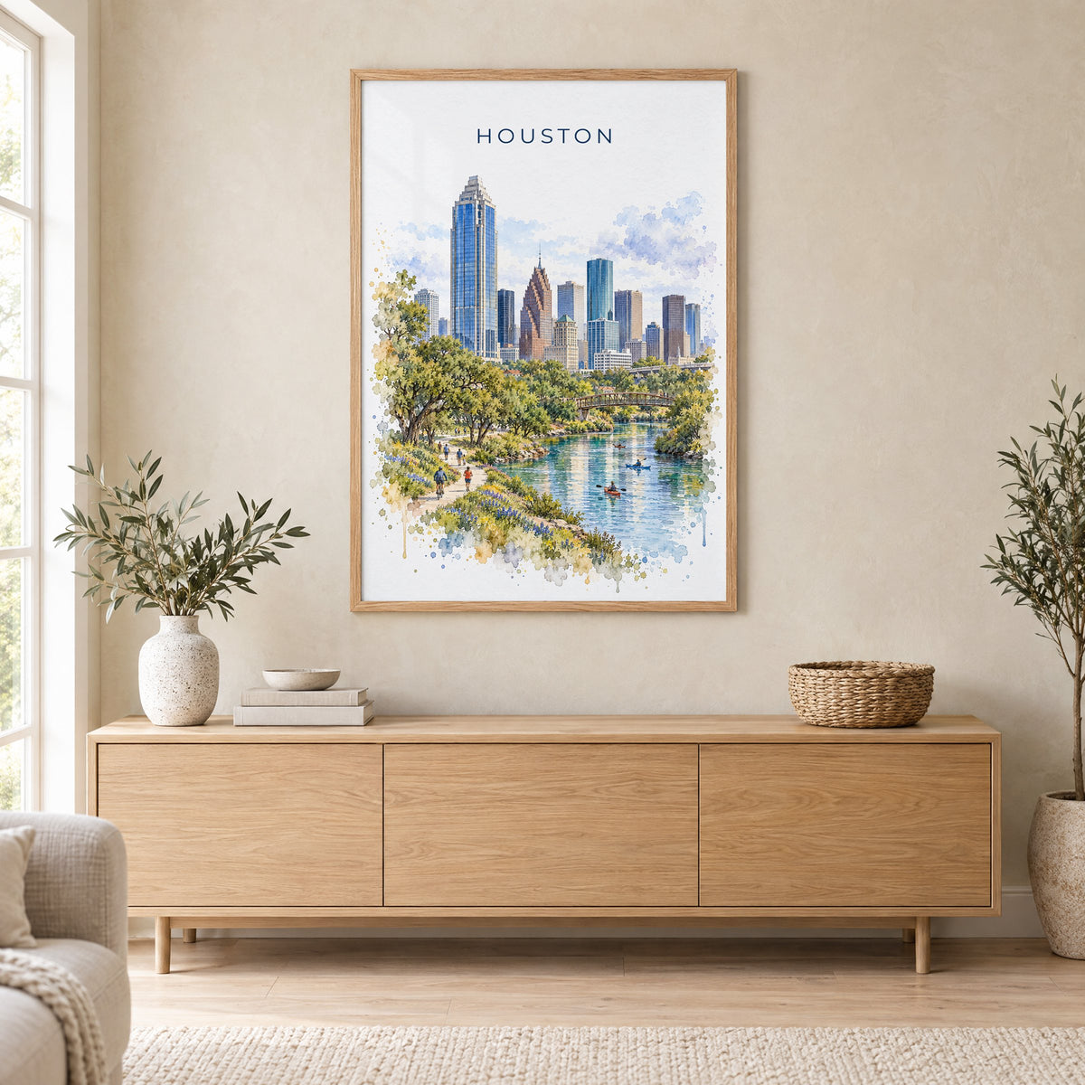Houston watercolor print in an oak frame above a light wood sideboard in a Scandinavian living room