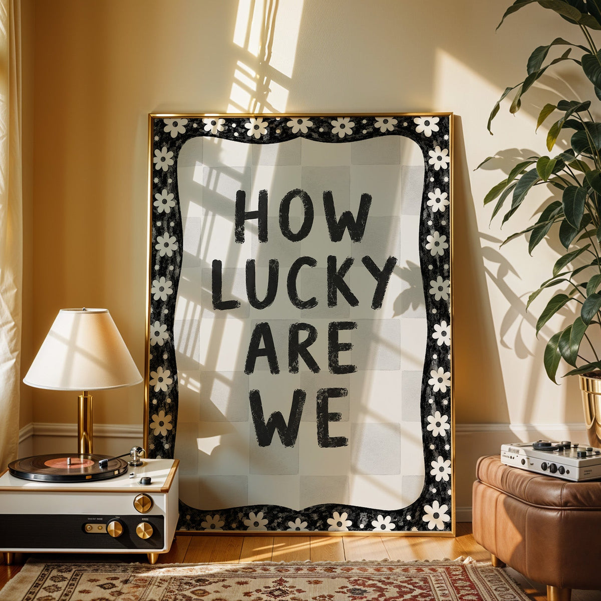 How lucky are we quote with white daisy border print shown in a gold frame beside a record player and table lamp