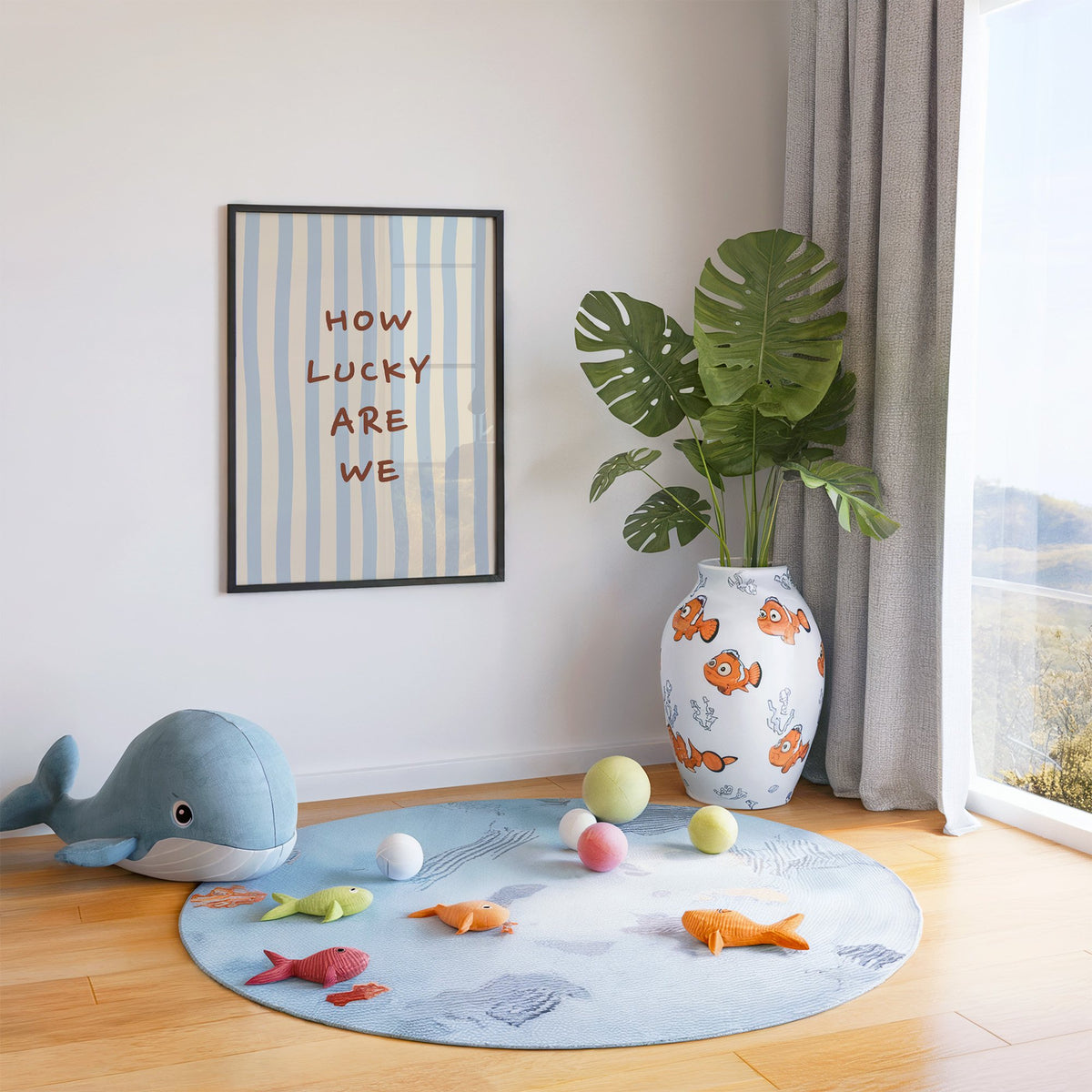 How lucky are we nursery print in a black frame in a playroom with an ocean rug and whale plush
