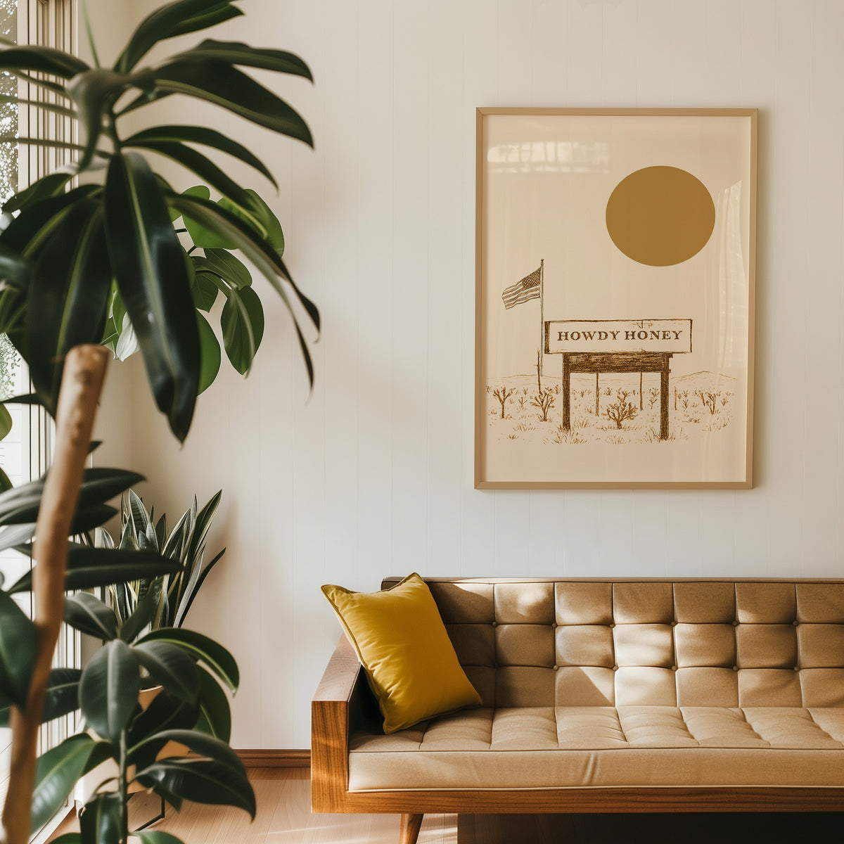 Howdy Honey desert billboard print in an oak frame above a tan leather sofa