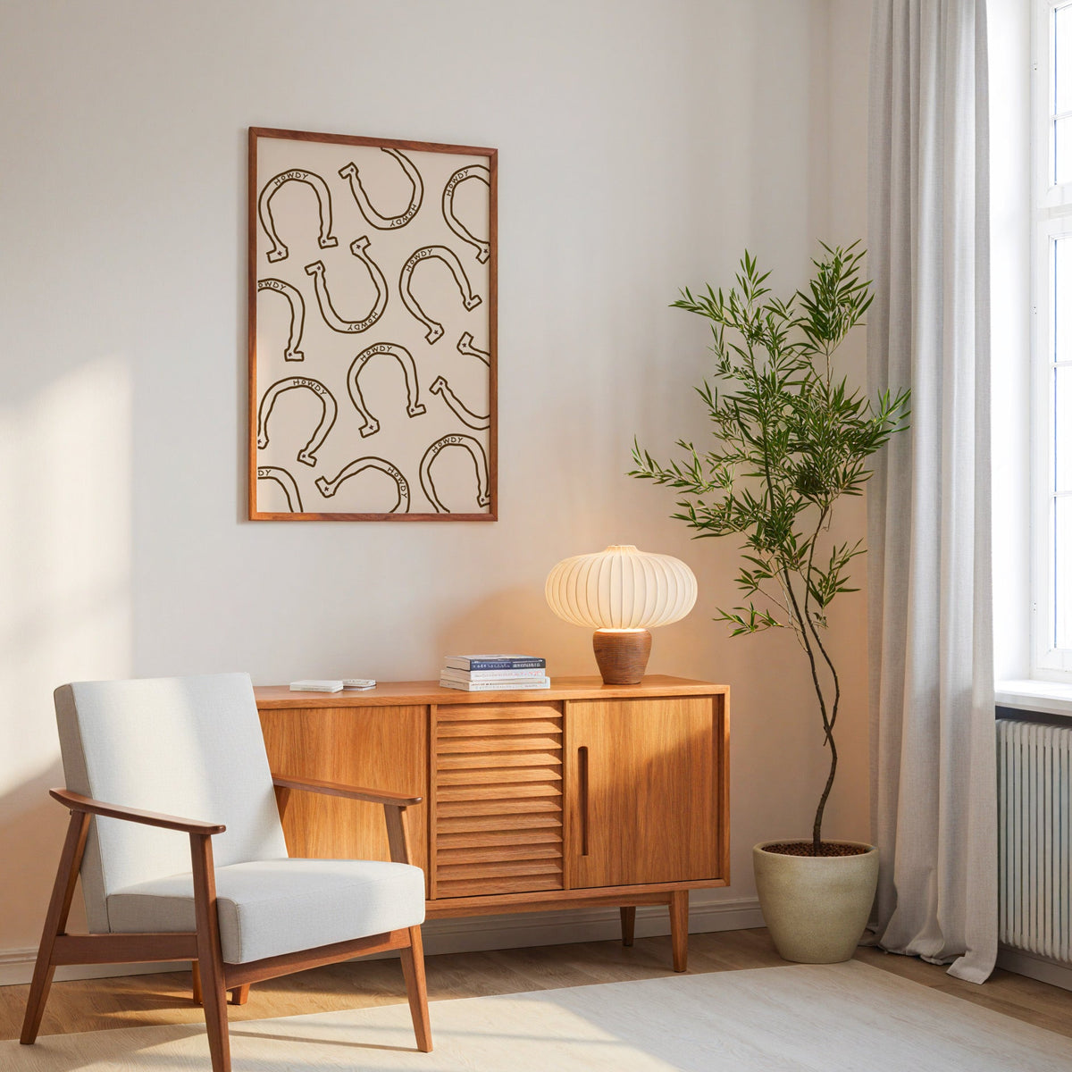 Howdy horseshoe cream pattern print in an oak frame above a mid-century sideboard