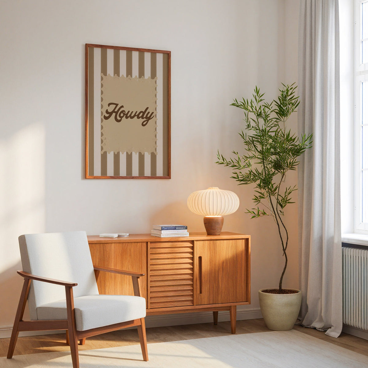 Howdy script stamp print in an oak frame above a mid-century sideboard