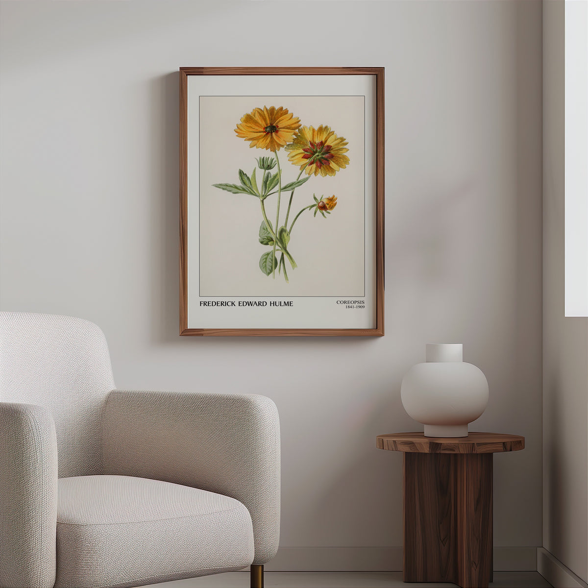 Vintage flower plate in a slim walnut frame above a bouclé armchair