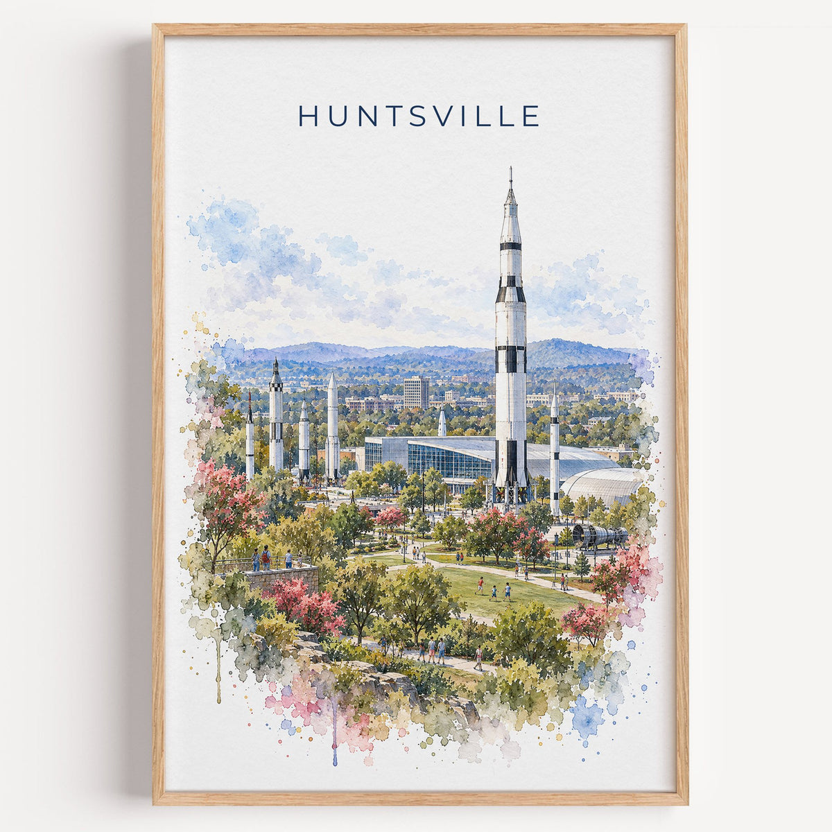 Huntsville watercolor print in a light oak frame on a plain white wall
