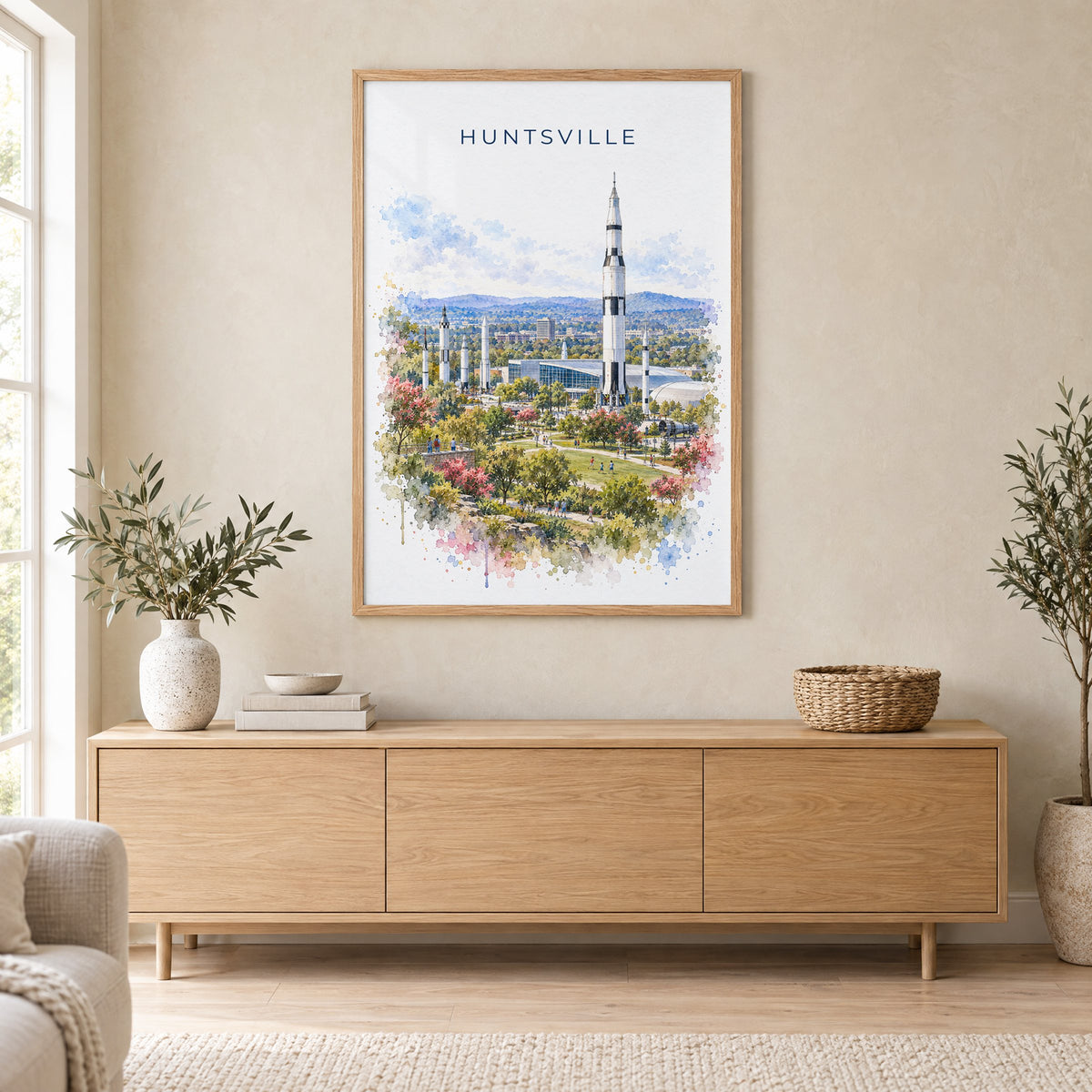 Huntsville watercolor print in an oak frame above a light wood sideboard in a Scandinavian living room