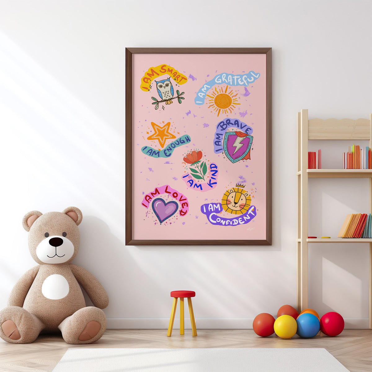 I am affirmations sticker nursery print in a walnut frame above a big teddy bear by a bookshelf