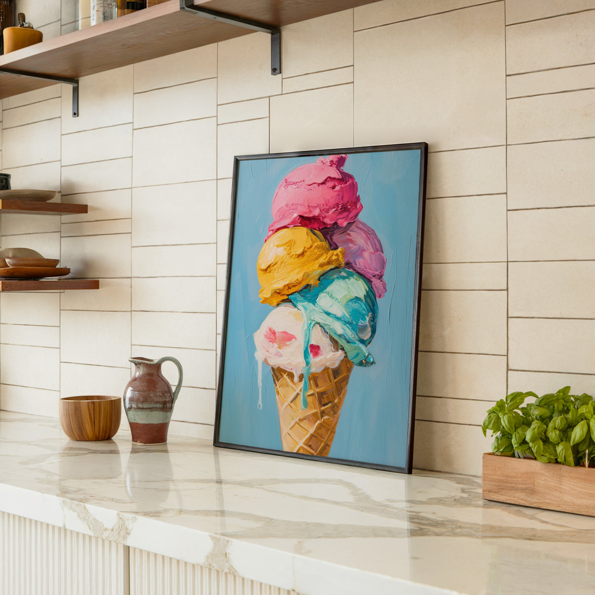 Ice cream cone print in a black frame leaning on a marble counter in a tiled kitchen